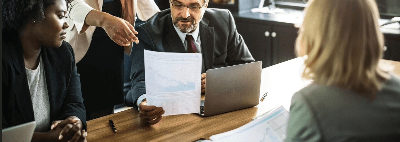 A business team looking at a document in a meeting